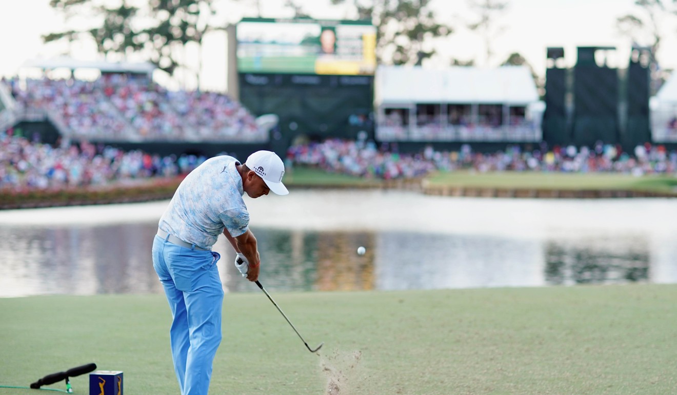 Rickie Fowler plays his tee shot from the infamous 17th tee at Sawgrass. Photo: AFP