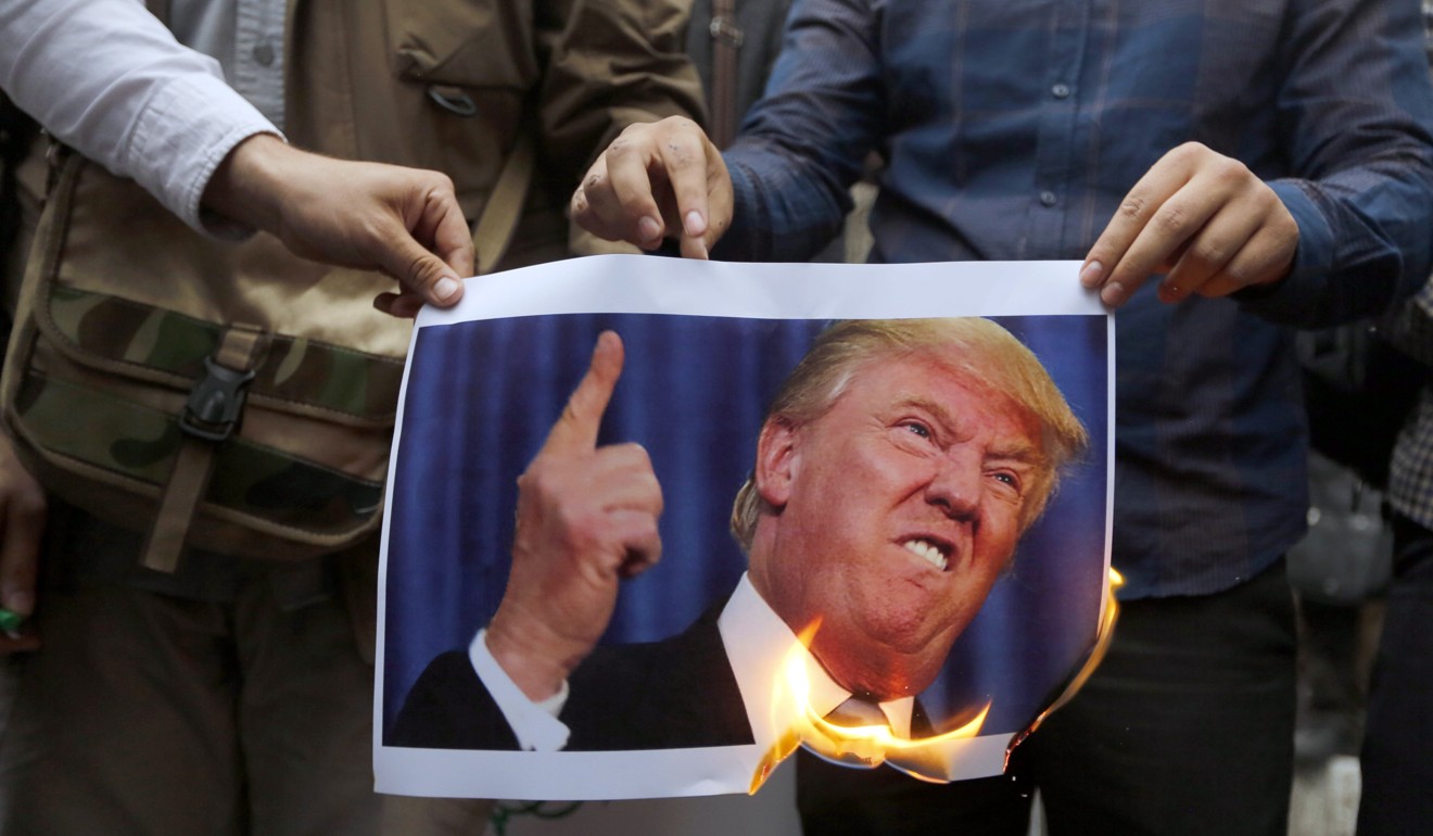 Iranians burn a picture of US President Donald Trump. Photo: EPA