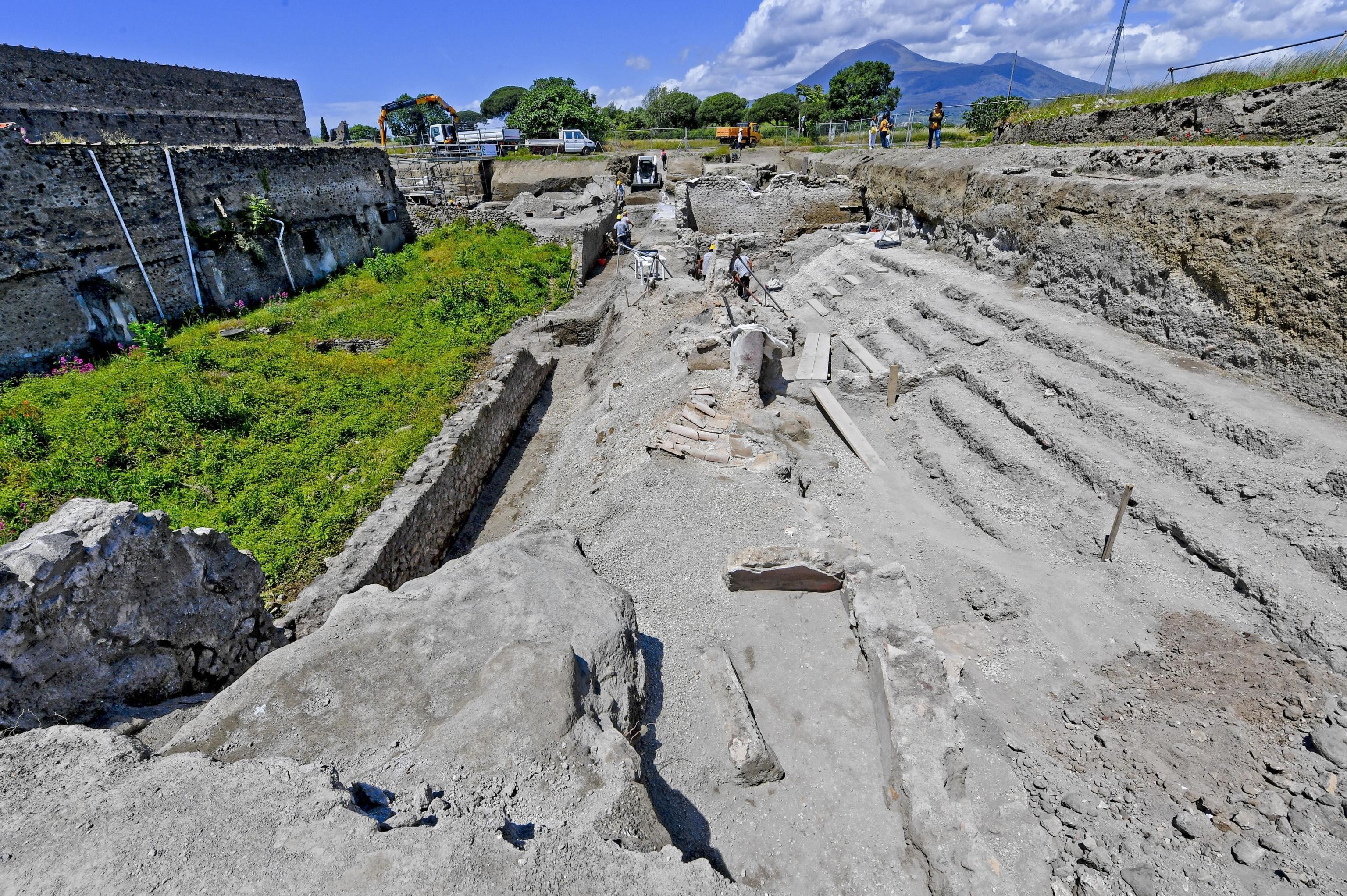 Archaeologists inspect excavation works in the archaeological site of Pompeii where they discovered a street of houses with intact balconies that were buried when Mt Vesuvius erupted in 79AD. Photo: AP