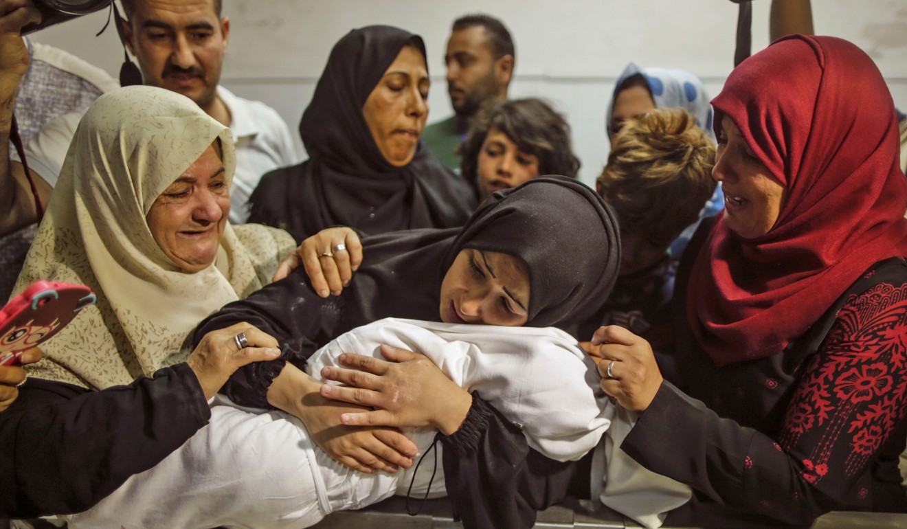 A Palestinian woman holds her baby, which died of tear gas inhalation fired by Israeli soldiers during protests according to the Palestinian health ministry, at al-Shifa hospital in Gaza City on Tuesday. Photo: AFP