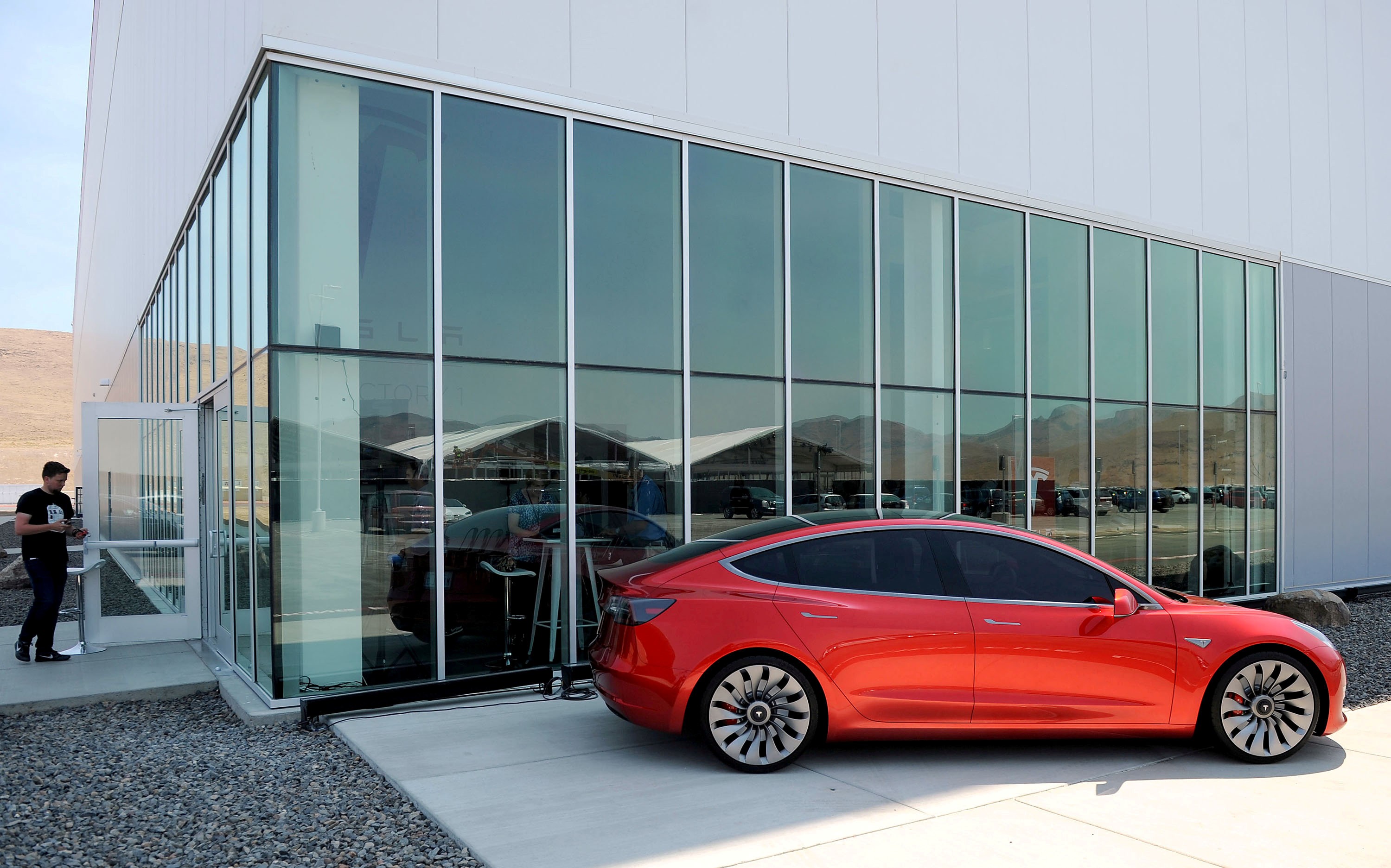 FILE PHOTO: A prototype of the Tesla Model 3 is on display in front of the factory during a media tour of the Tesla Gigafactory which will produce batteries for the electric carmaker in Sparks, Nevada, U.S. July 26, 2016. REUTERS/James Glover II/File Photo