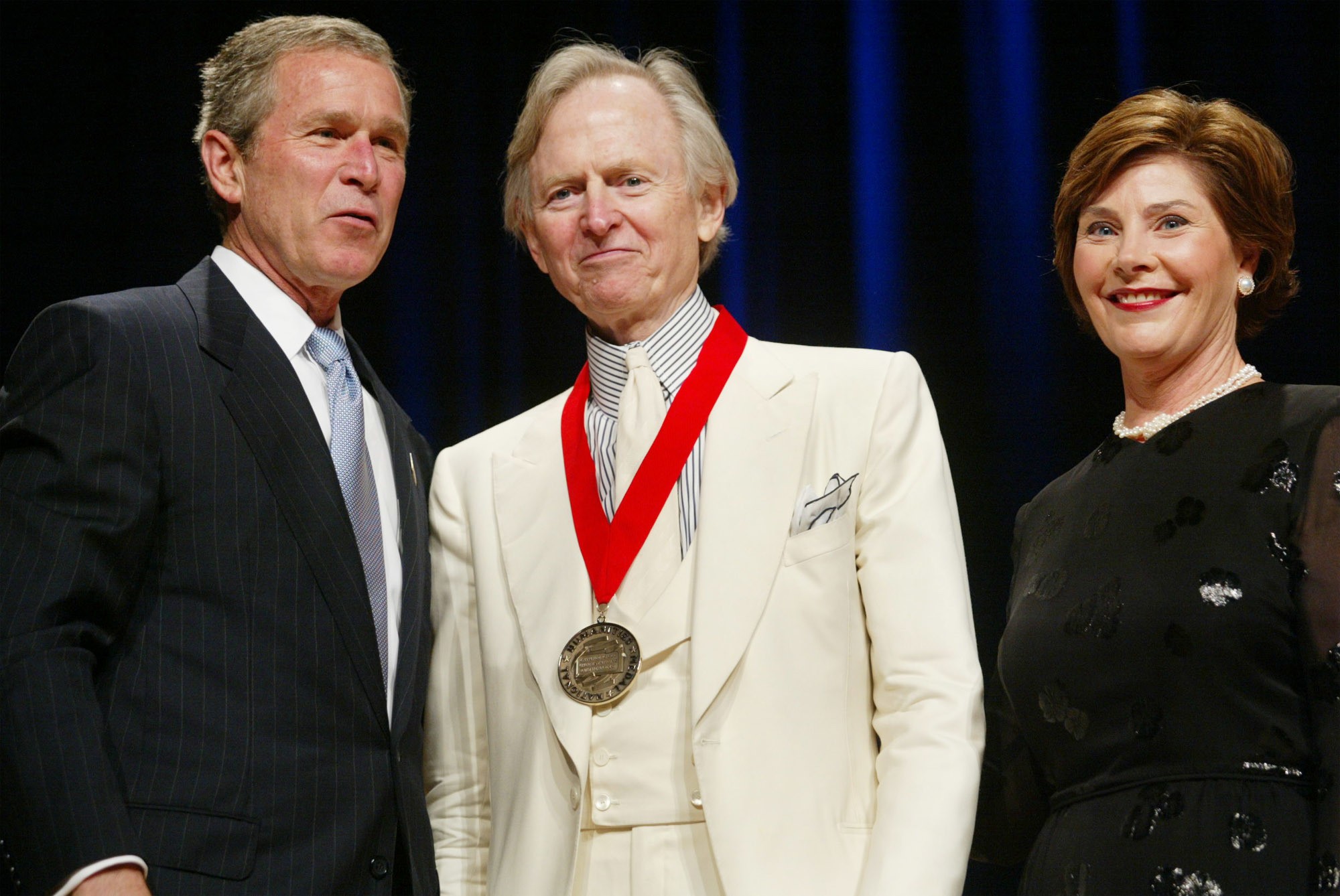 Author Tom Wolfe poses with then-president George W. Bush, and first lady Laura Bush during the National Endowment for the Arts National Medal Awards ceremony at Constitution Hall in Washington in 2002, where Wolfe was a recipient of the National Humanities Medal. Photo: AP 