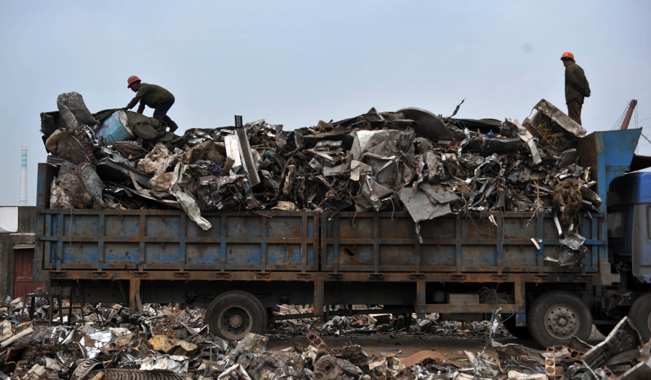 A file picture taken in 2011 of workers loading imported waste metal at a port in Taizhou in Zhejiang province. Photo: China Foto Press