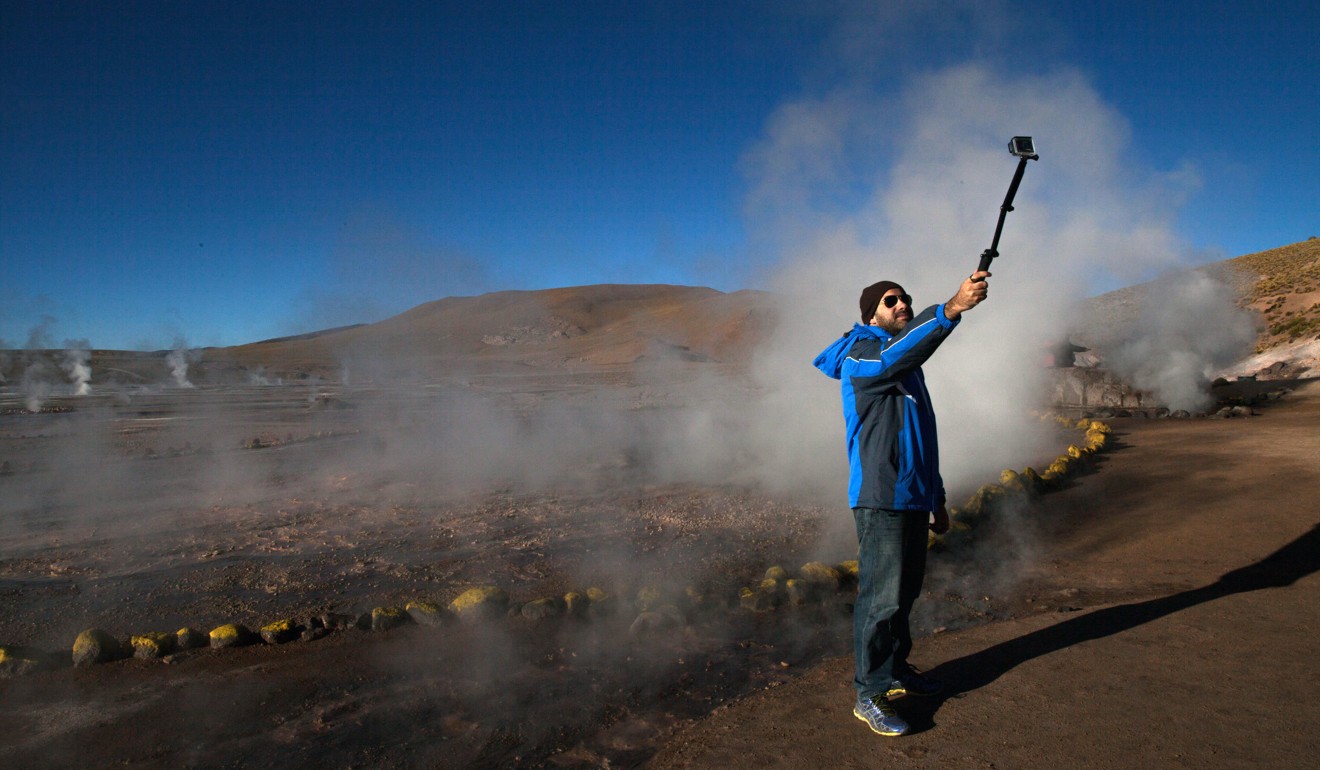 A visitor snaps a selfie at El Tatio geyser field, in Chile.