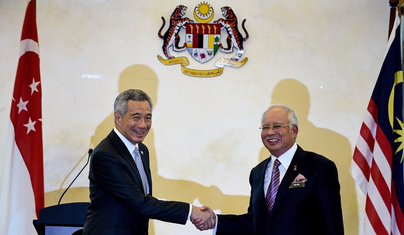 Singapore Prime Minister Lee Hsien Loong shakes hands with then-Malaysian Prime Minister Najib Razak in 2016 after a signing ceremony for the construction of a high speed rail link between Singapore and Kuala Lumpur. File photo: AFP