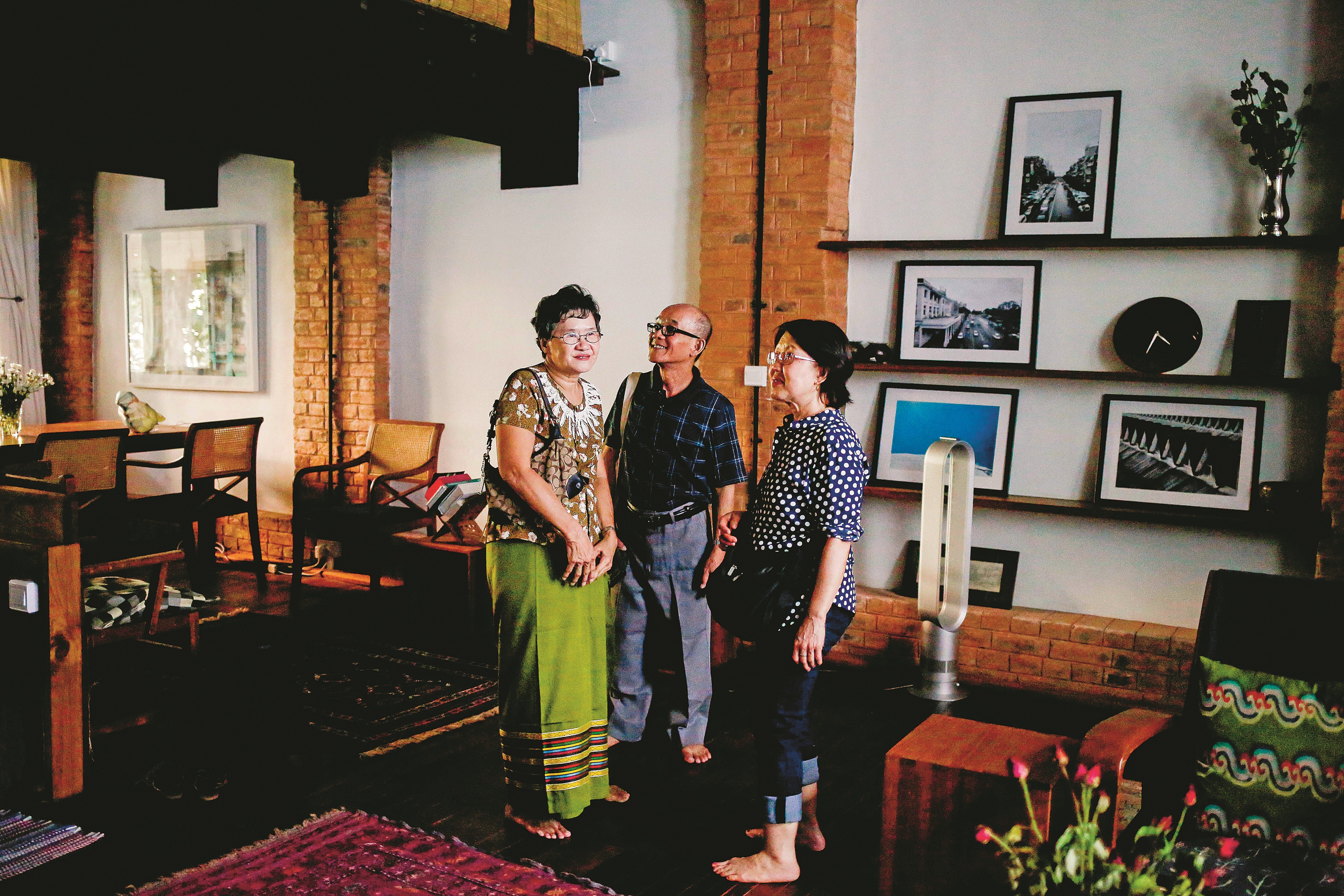 Thein Aung (centre) and his family travelled back to Myanmar from the United States to see the renovated family house. Photo: Ann Wang