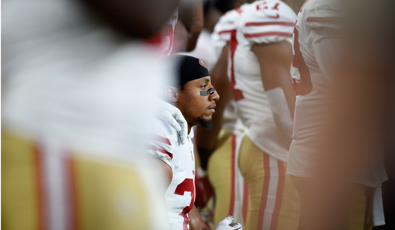 Eric Reid kneels during the National Anthem. Photo: AFP