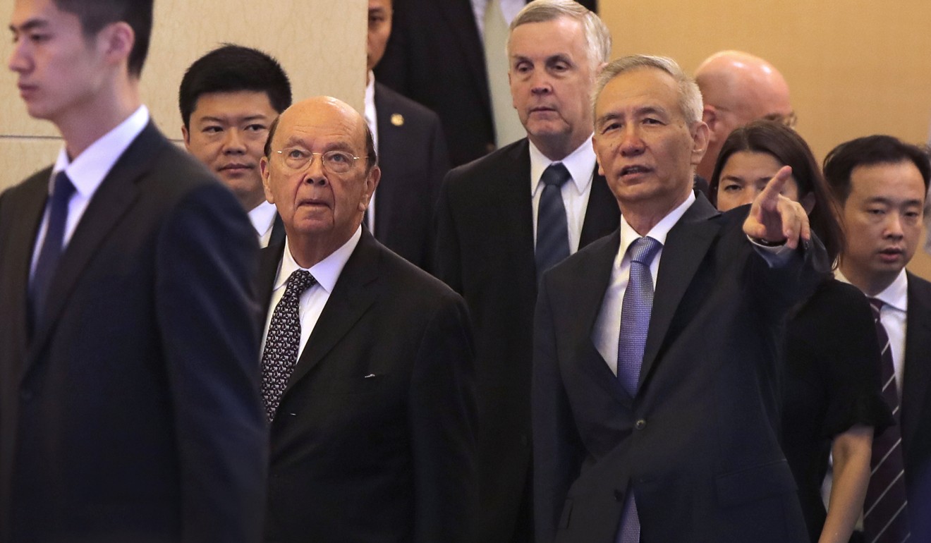 US Commerce Secretary Wilbur Ross (second left) and Chinese Vice-Premier Liu He (right) arrive for their meeting at the Diaoyutai State Guesthouse in Beijing on Sunday. Photo: EPA-EFE