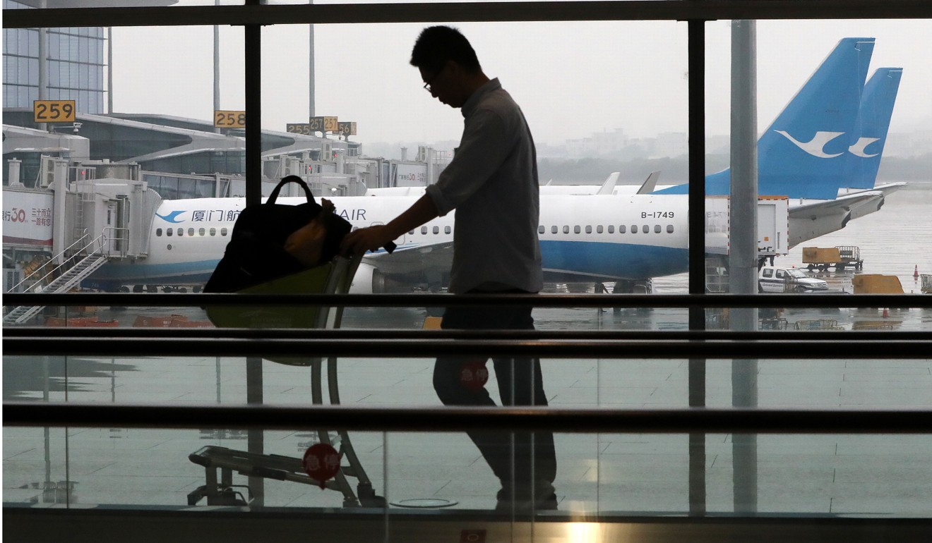 A traveller at Guangzhou Baiyun International Airport. Photo: Edward Wong