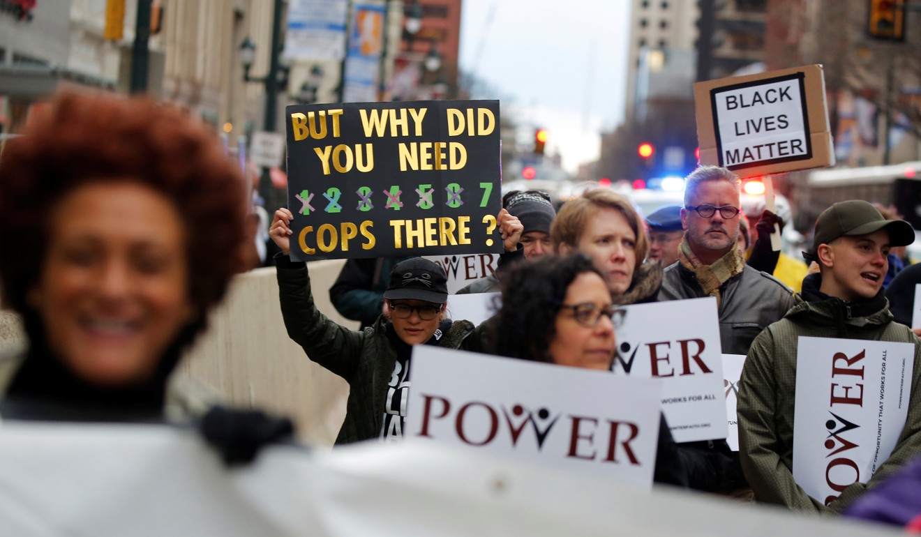 Protesters march down Market Street in Philadelphia on April 19, a week after two black men were arrested at a Starbucks coffee shop. Photo: Reuters