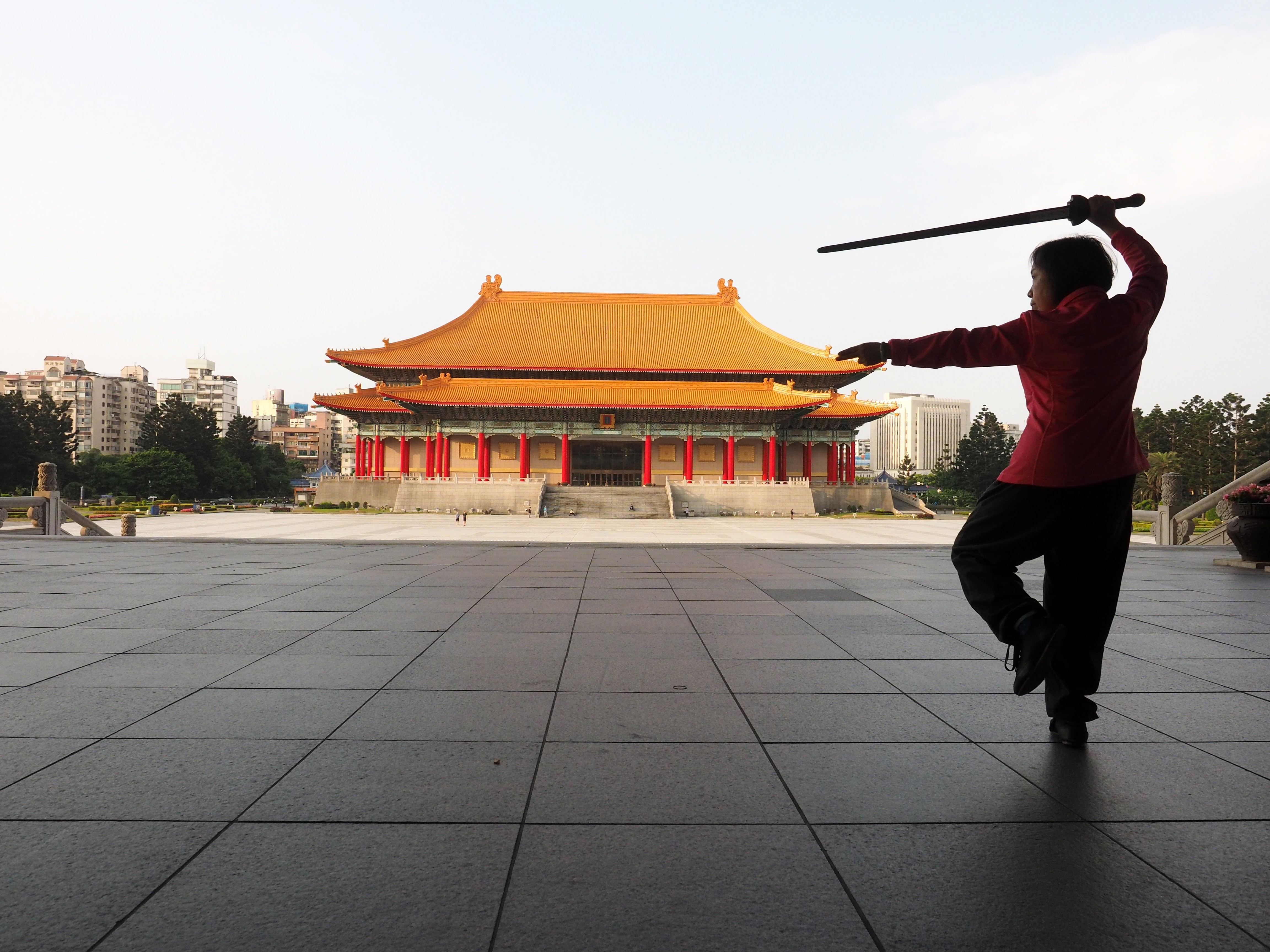 A woman practises tai chi in front of the National Theatre in Taipei in March. Taiwan must take steps to maintain its competitive edge in the face of rising China. Photo: EPA-EFE
