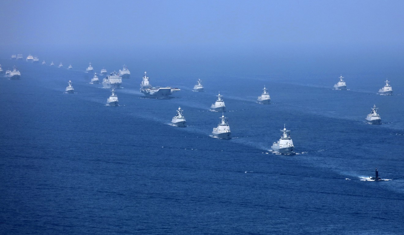In this April 12 photo released by Xinhua News Agency, China’s Liaoning aircraft carrier is accompanied by navy frigates and submarines conducting an exercises in the South China Sea. Photo: Xinhua via AP