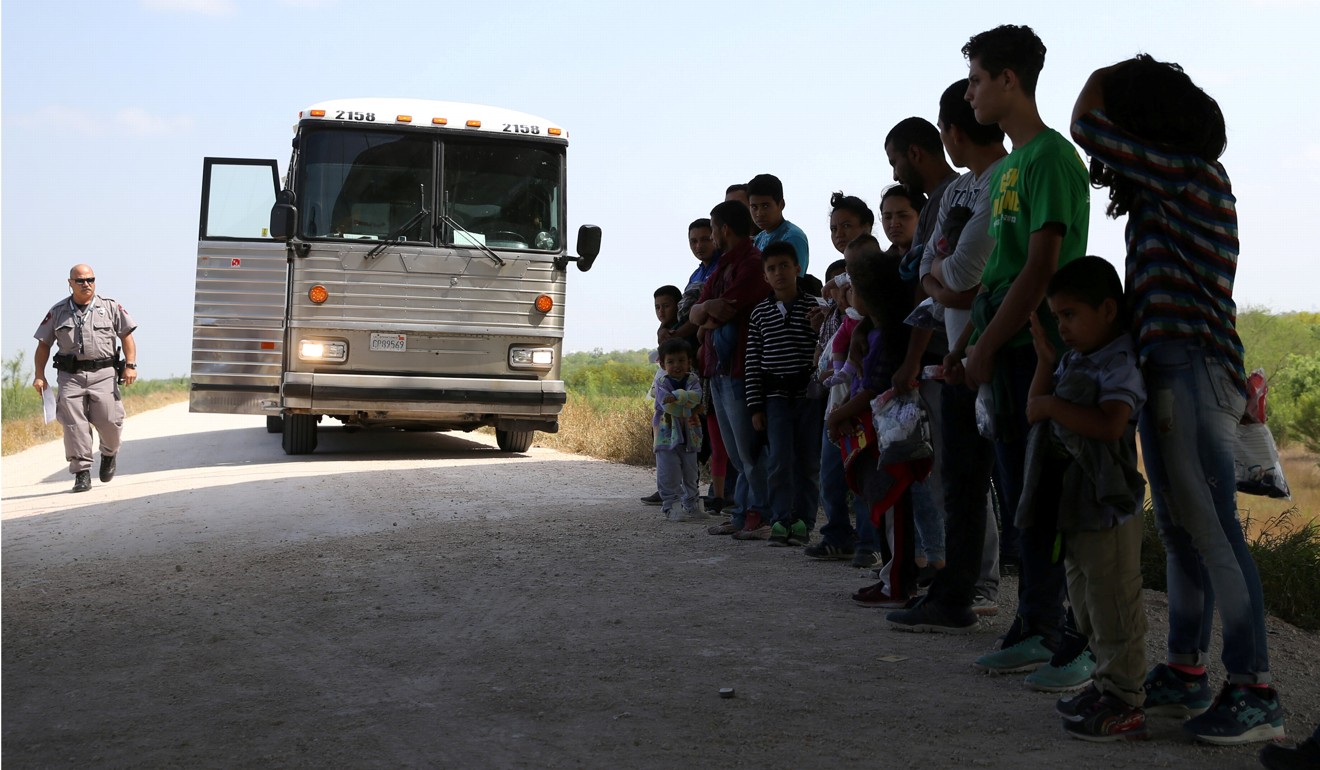 Immigrants who turned themselves in to border patrol agents after illegally crossing the border from Mexico into the US wait to be transported for processing in the Rio Grande Valley sector, near McAllen, Texas, on April 2. Photo: Reuters