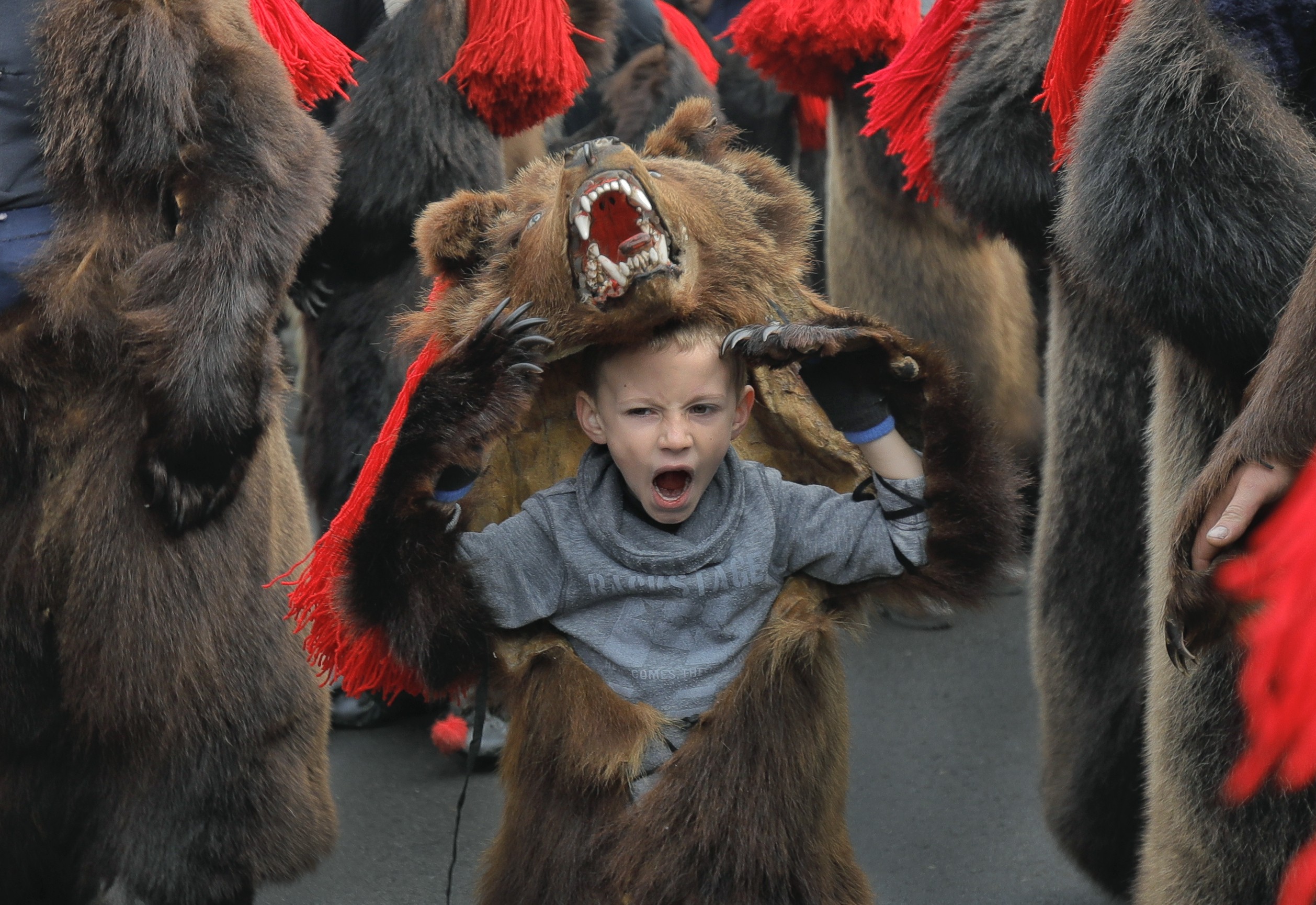 A child wears a bear costume as part of a new year ritual in Comanesti, northern Romania, on December 30, 2017. Slowing macroeconomic indicators, rising interest rates and political uncertainty have prompted warnings that a bear market may be about to bite investors. Photo: AP