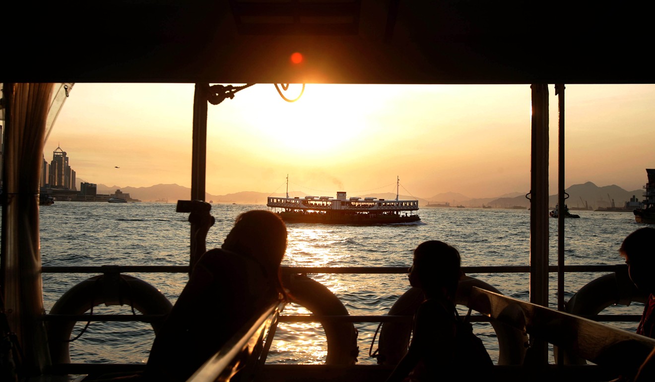 Passengers soak in the sunset on a Star Ferry ride. Photo: Samantha Sin