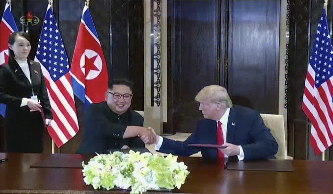 North Korean leader Kim Jong-un shakes hands with US President Donald Trump while his sister Kim Yo-jong looks on during a summit meeting in Singapore on June 12. Photo: KRT via AP