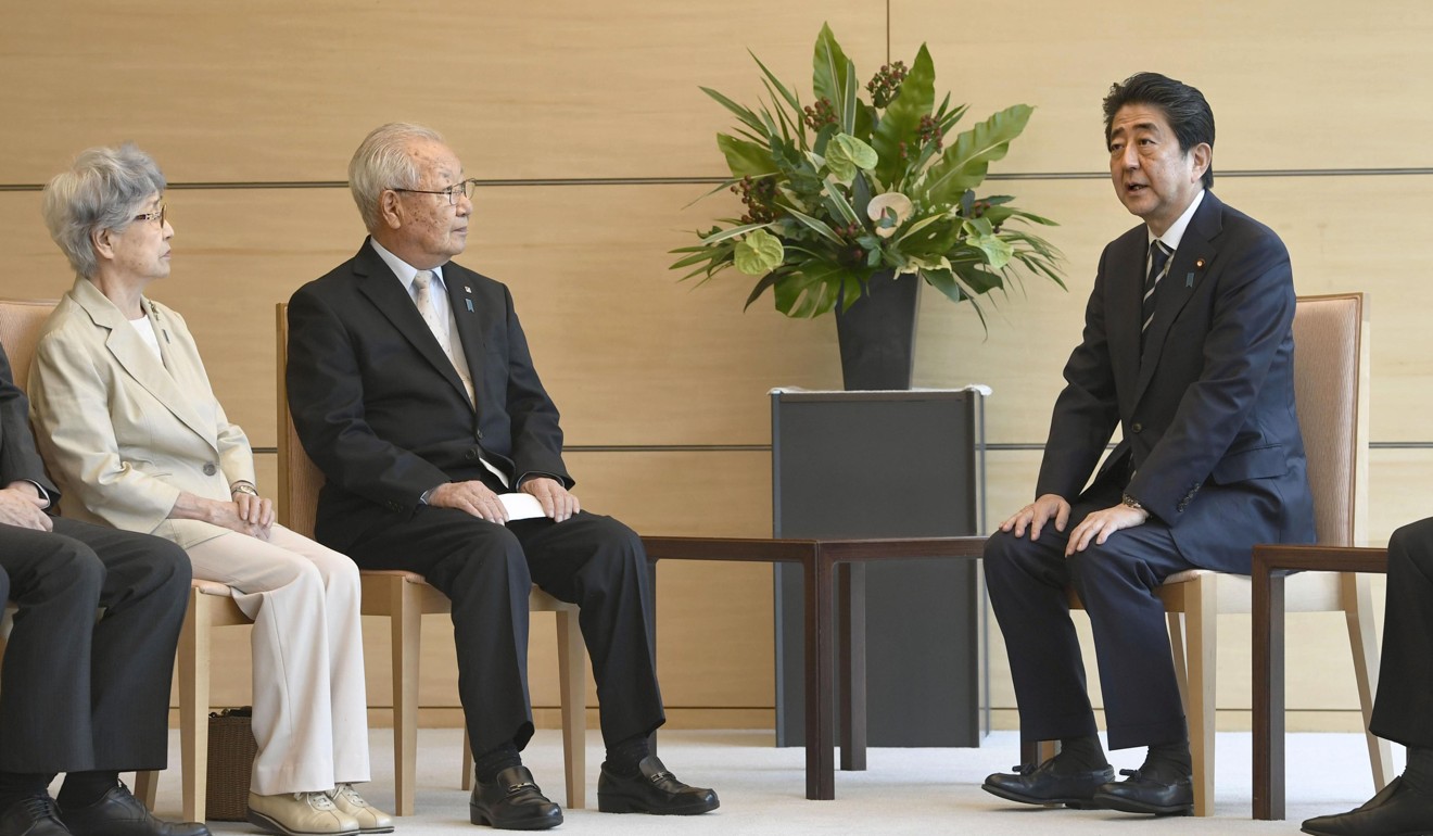 Abe meeting with members of a group representing abductees' families at his office in Tokyo on Thursday. Photo: Kyodo