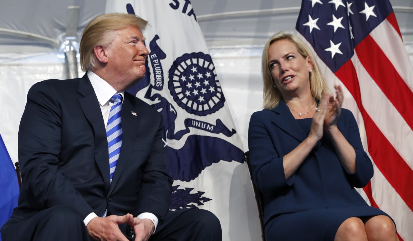 Homeland Security Secretary Kirstjen Nielsen, right, applauds President Donald Trump as they attend a change-of-command ceremony at the US Coast Guard Headquarters on Friday, June 1, in Washington. Photo: AP
