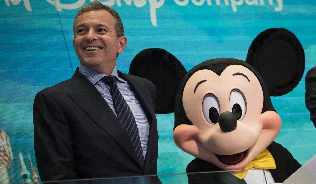 Chairman and chief executive officer of Walt Disney Company Robert Iger with Mickey Mouse in November 2017. Photo: Getty Images