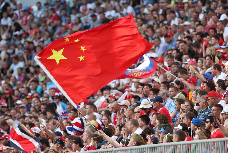 A fan waves the Chinese flag during the World Cup match between Costa Rica and Serbia in Samara, Russia. Photo: EPA