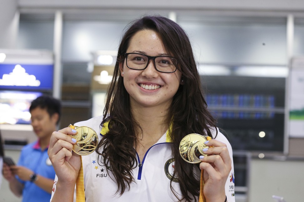 Haughey shows off her two gold medals at Hong Kong International Airport after returning from the World University Games in Taipei. Photo: Dickson Lee