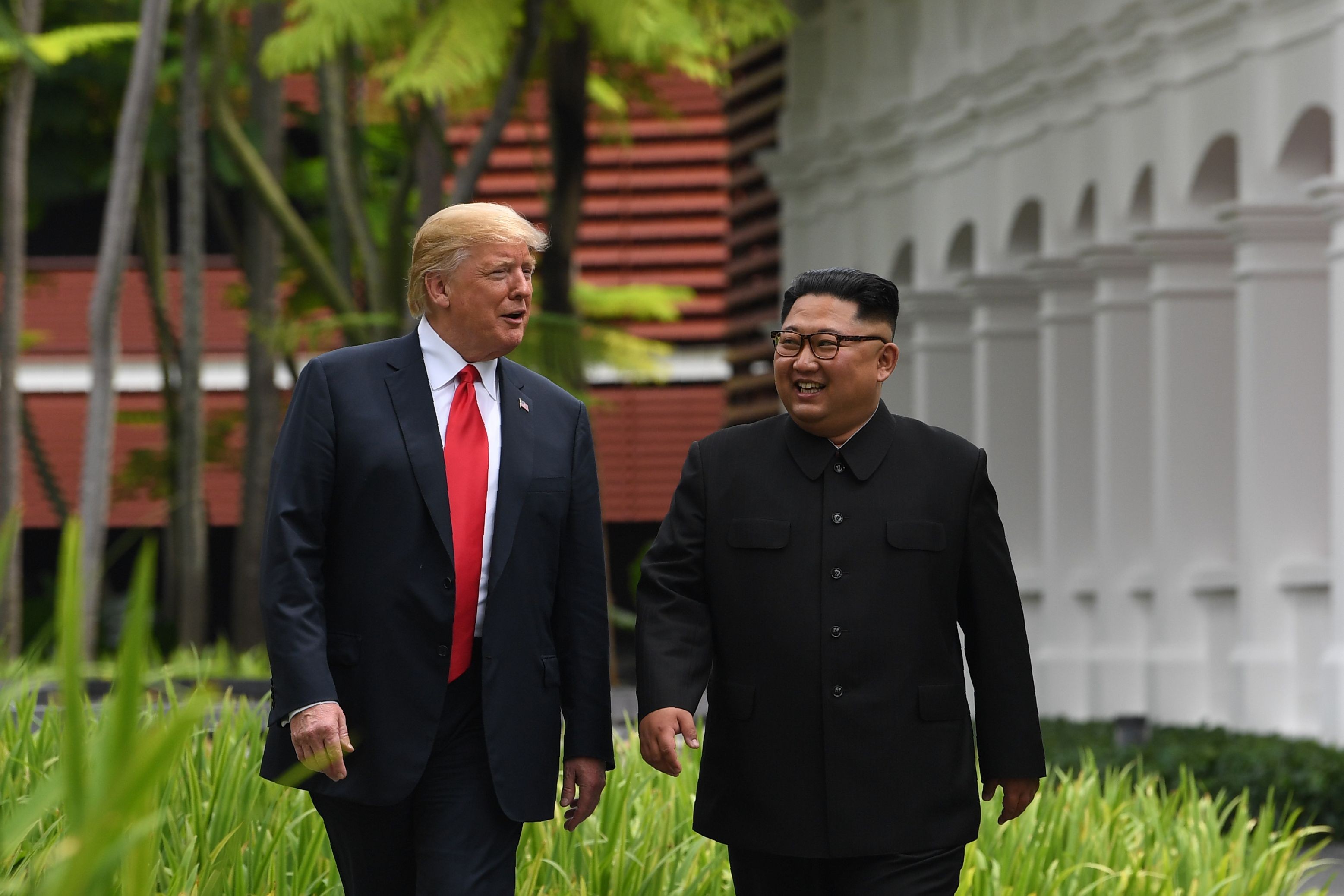 North Korea’s leader Kim Jong-un (right) walks with US President Donald Trump during a break in talks at their historic US-North Korea summit, at the Capella Hotel on Sentosa island in Singapore on June 12. Trump and Kim became the first sitting US and North Korean leaders to meet to negotiate an end to the decades-old nuclear stand-off on the Korean peninsula. Photo: AFP