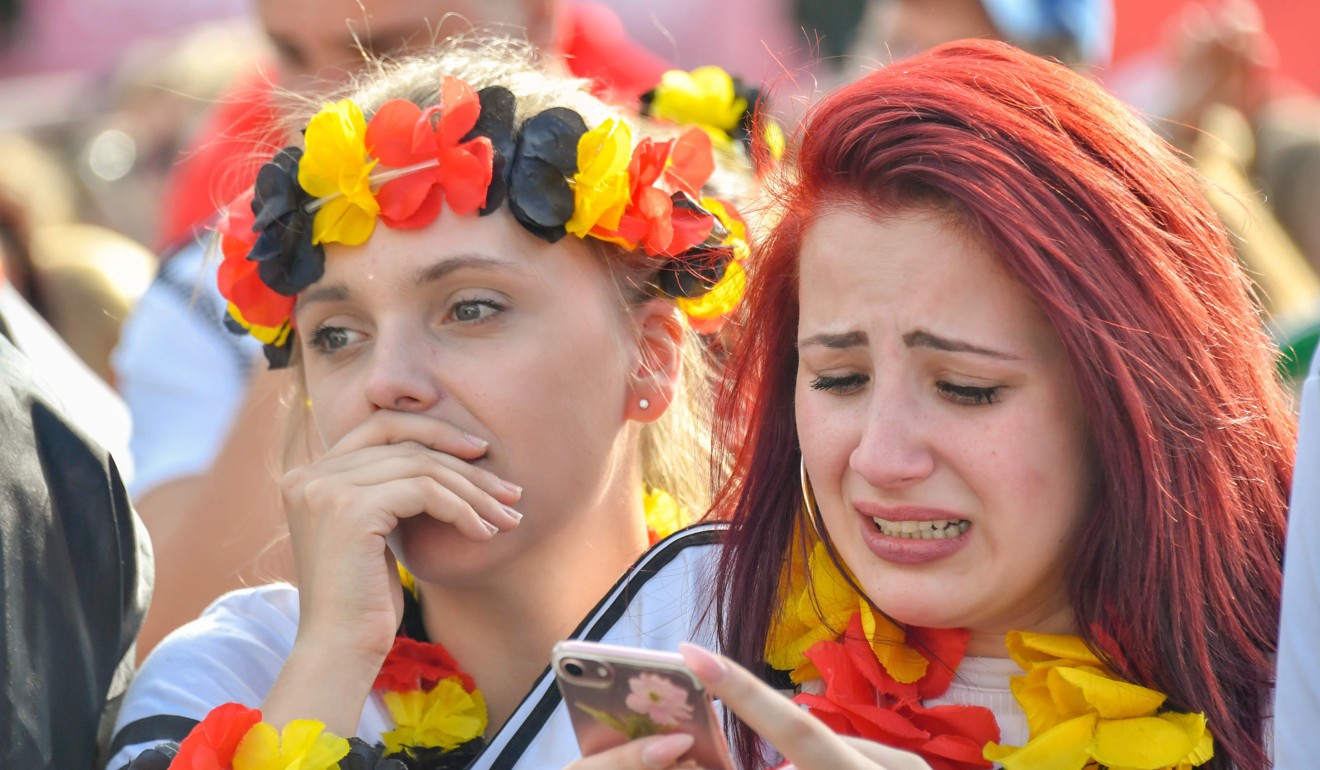 Germany supporters cry at a public viewing event at the Fanmeile in Berlin after the defeat to South Korea. Photo: AFP