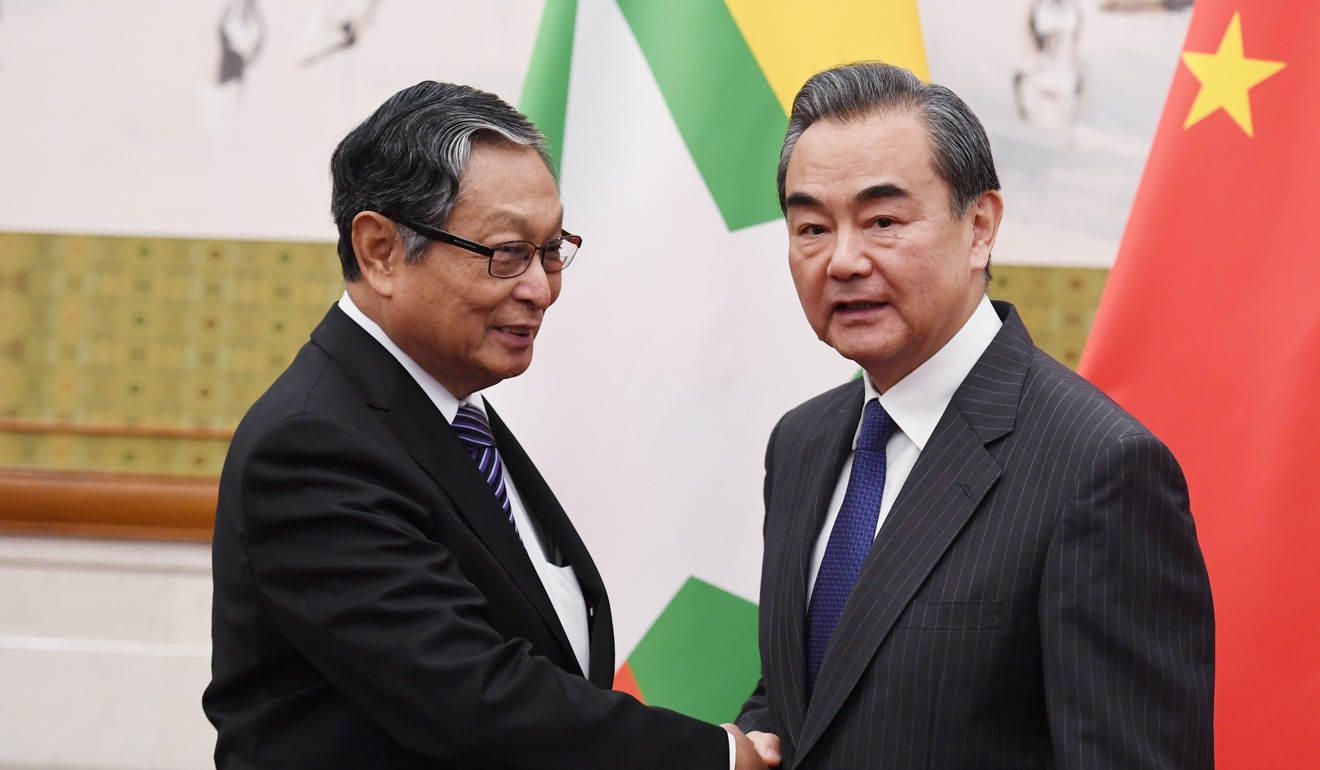 Chinese Foreign Minister Wang Yi (right) shakes hands with Myanmar's Minister of the Office of the State Counsellor Kyaw Tint Swe at the Diaoyutai State Guesthouse in Beijing. Photo: Reuters