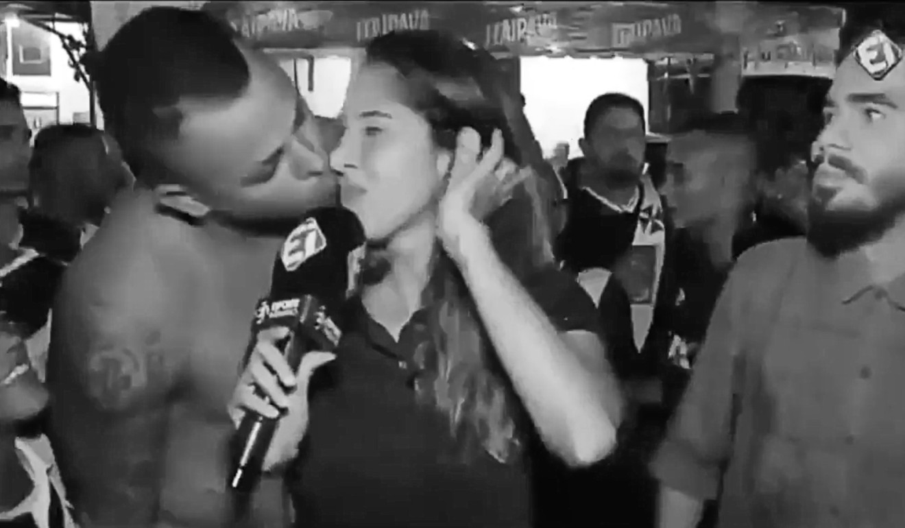 A still from a video released by the #DeixaElaTrabalhar movement showing a female Brazilian sports reporter being kissed by a fan.