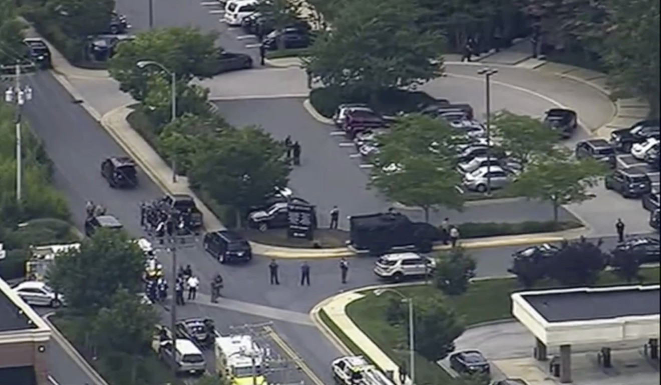 People leaving the Capital Gazette offices where multiple people had been shot on Thursday in Annapolis, Maryland. Photo: WJLA via AP