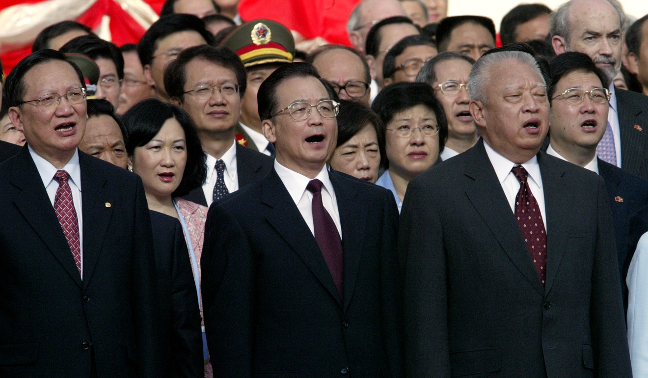 Wen Jiabao (centre), China’s premier in 2003, sings the national anthem during the July 1 ceremony that year, alongside then chief executive Tung Chee-hwa (right) and other officials at Golden Bauhinia Square. Photo: Handout