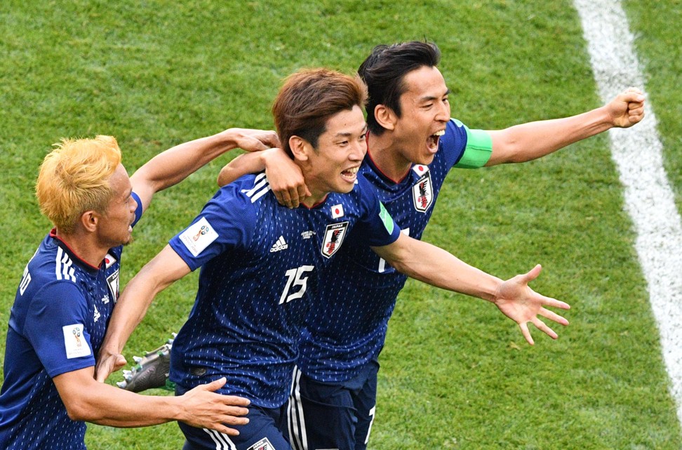 Yuya Osako (centre) celebrates with Yuto Nagatomo (left) and Makoto Hasebe after scoring Japan’s second goal against Colombia. Photo: AFP