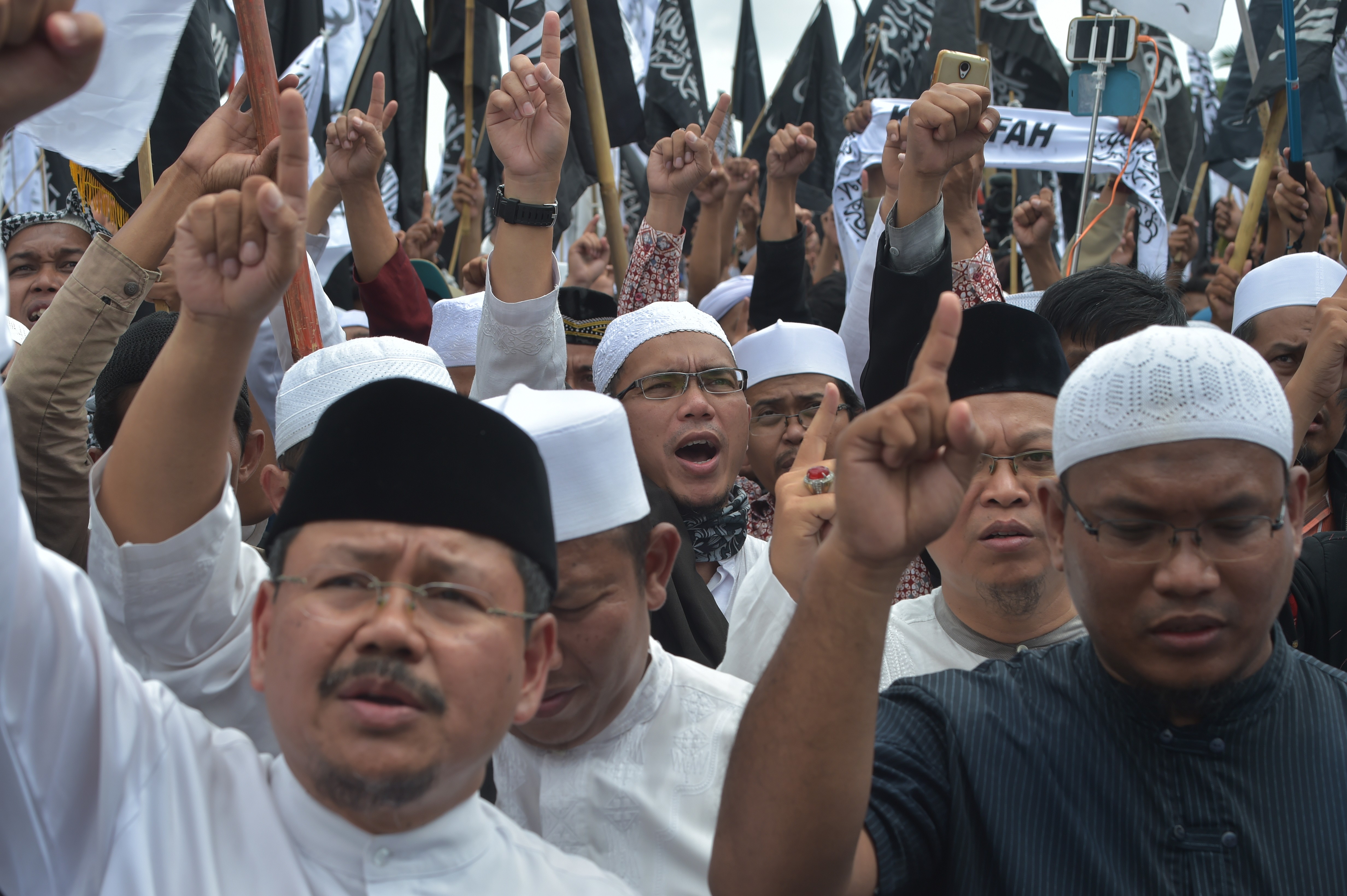 Indonesian Muslims shout slogans at the National Monument in Jakarta on February 5, 2017, during a rally to support the country’s clerics, including Rizieq Shihab, leader of the Front Pembela Islam, who helped organise mass protests against Jakarta governor and ethnic Chinese Christian Basuki Tjahaja Purnama for allegedly insulting Islam. Photo: AFP