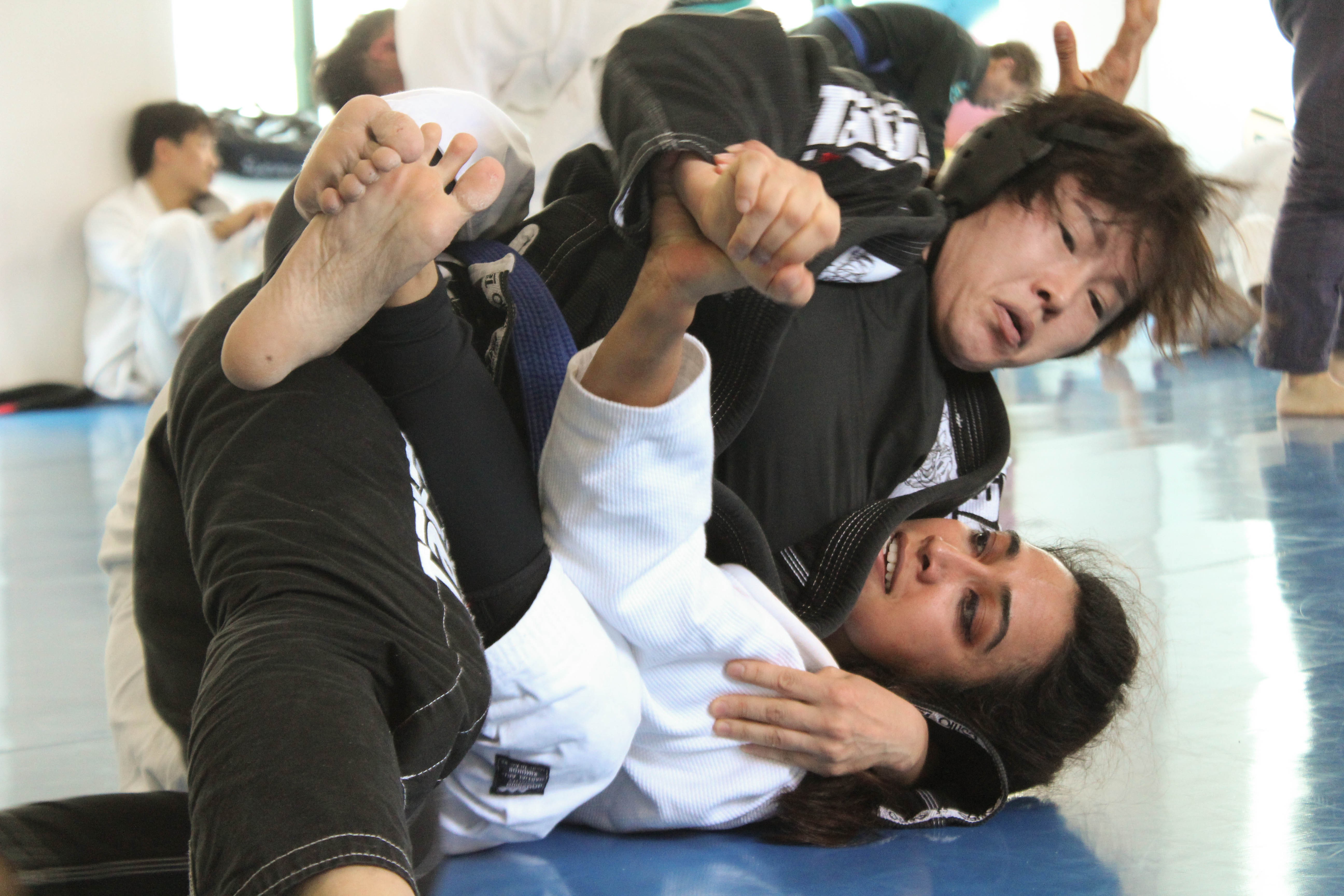 Brazilian jiu-jitsu brown belt Nilofer Mallick (bottom), an airline pilot living in Seoul, grappling with an opponent. Photo: Courtesy of Nilofer Mallick