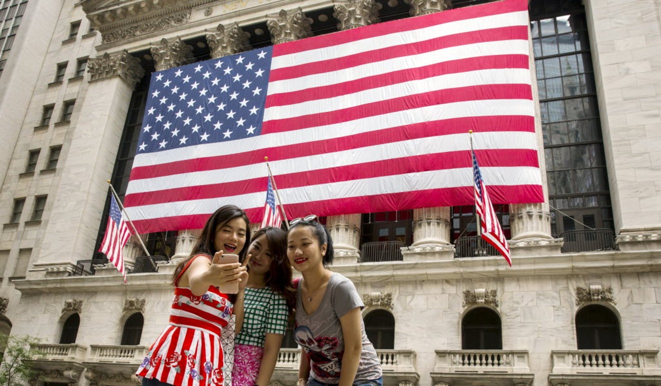 Chinese tourists take a selfie in front of the New York Stock Exchange. Picture: Reuters