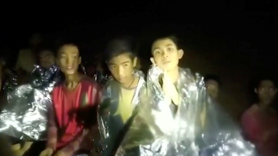 Boys from the football team trapped inside Tham Luang cave greet members of the Thai rescue team in Chiang Rai, Thailand, in this still image taken from a July 3 video by Thai Navy Seal. Photo: Reuters