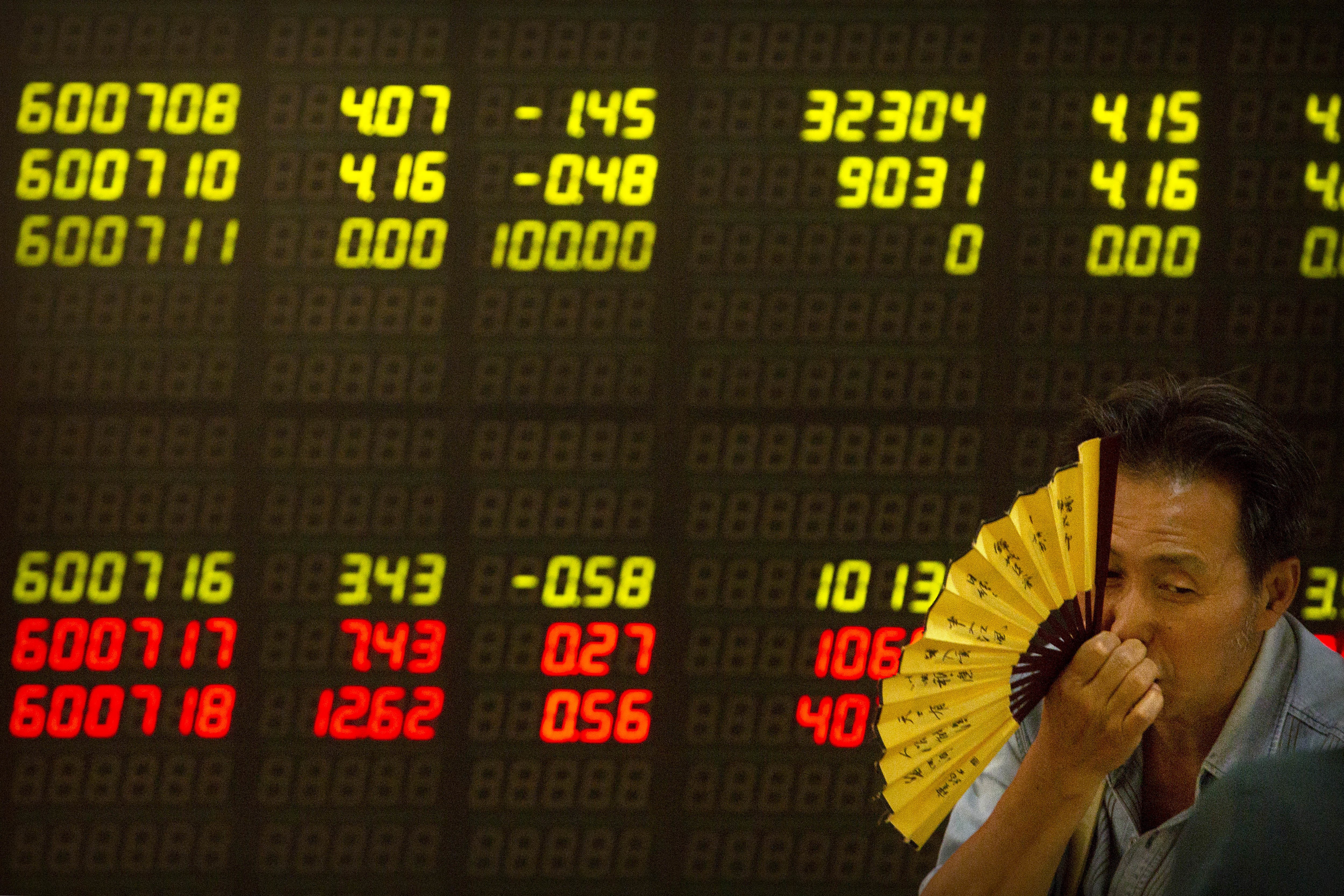 A Chinese investor monitors stock prices at a brokerage house in Beijing on July 6. Photo: AP