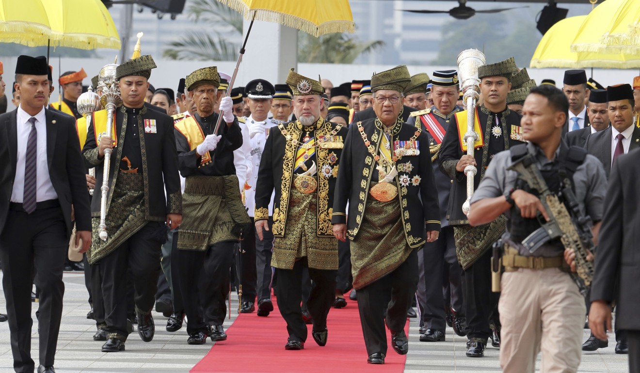 Malaysia King Sultan Muhammad V walking to parliament. Photo: AP