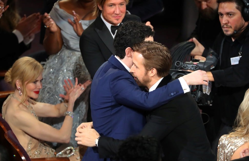 Damien Chazelle is congratulated by actor Ryan Gosling for winning an Oscar for Best Director for ‘La La Land’. Photo: Reuters