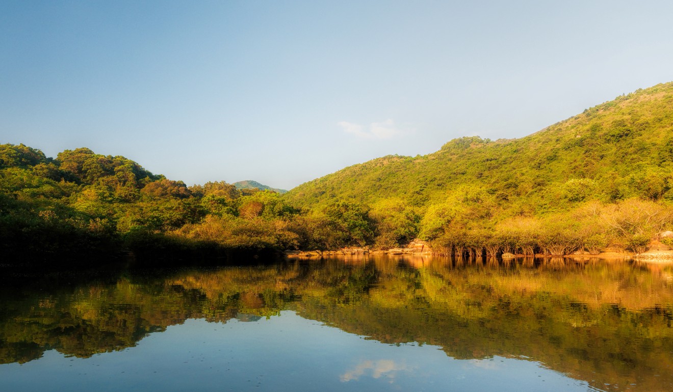 A peaceful lagoon reflects the surrounding scenery in Hoi Ha. Photo: Martin Williams