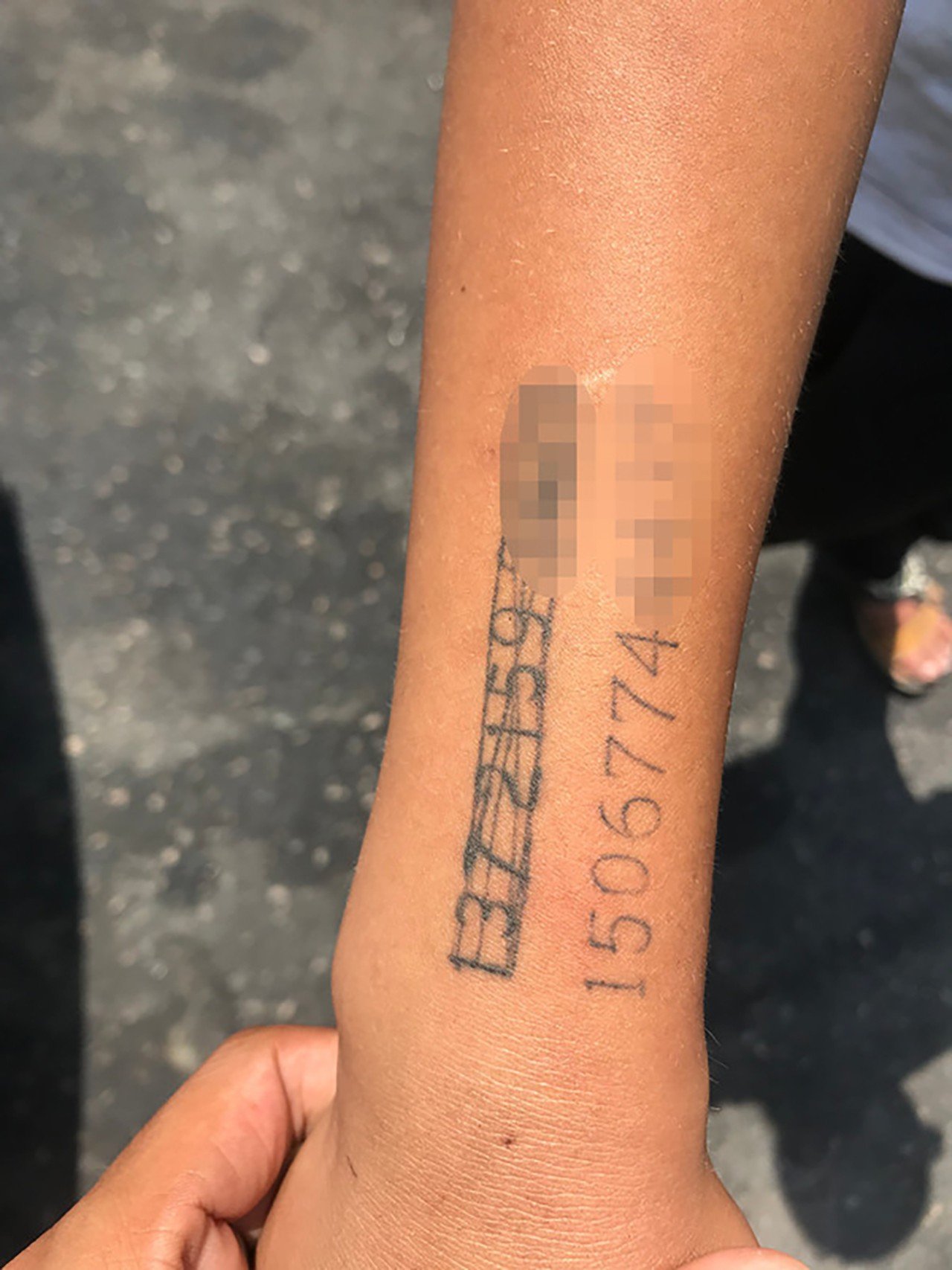 A Chinese woman had her phone numbers tattooed on her son’s arm so people could call her if he got lost. Photo: Qq.com