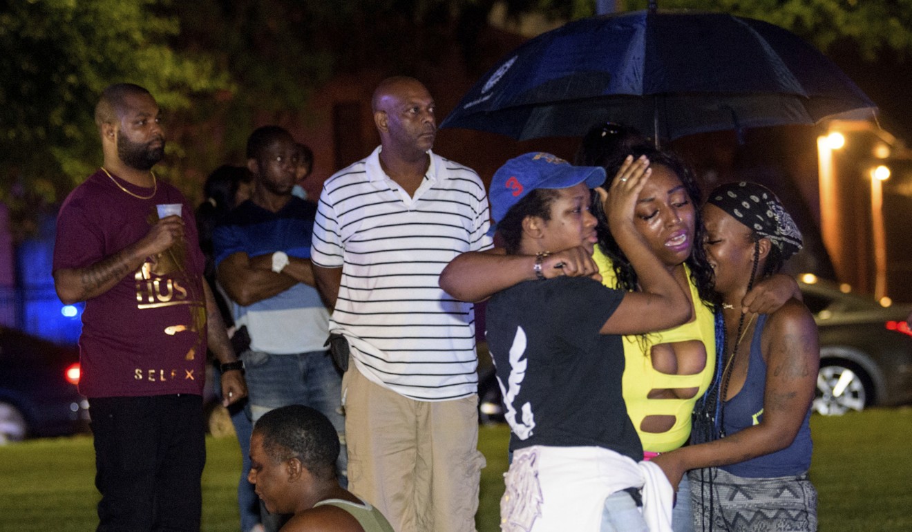 People at the scene of the shooting. Photo: The Advocate via AP
