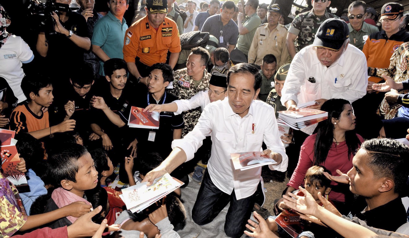 President Joko Widodo visited affected areas on Monday and promised financial support for those who have lost their homes. Photo: EPA