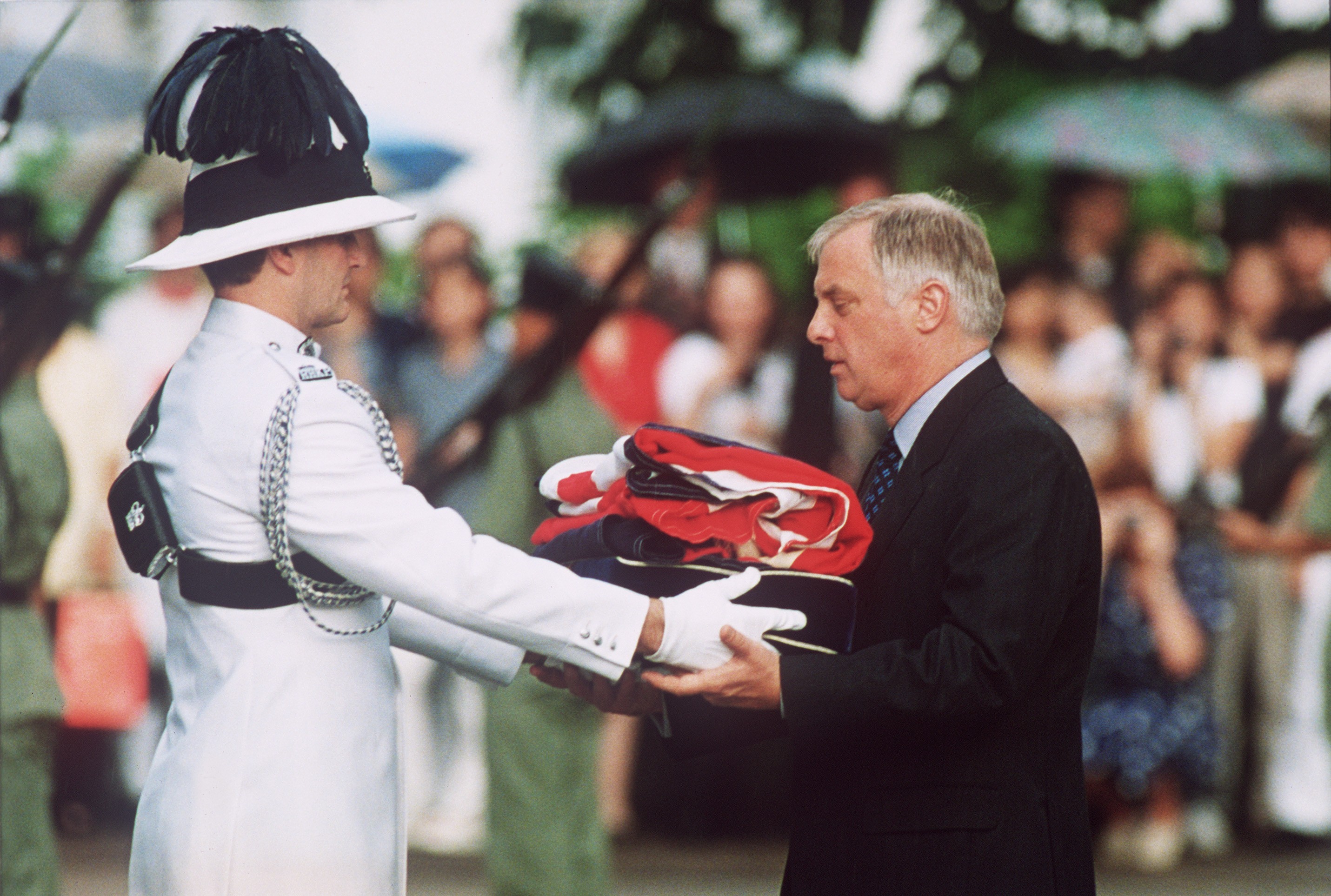 Chris Patten, the last governor of colonial Hong Kong, receives the Union Flag after it was lowered for the last time at Government House on June 30, 1997. Photo: AFP
