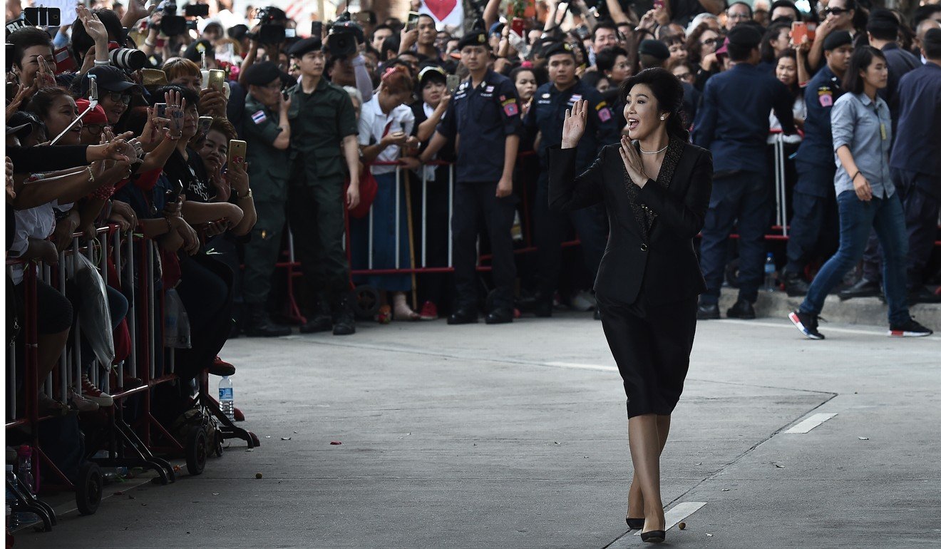 Yingluck waves to supporters outside the Supreme Court in Bangkok on August 1, 2017. Photo: AFP