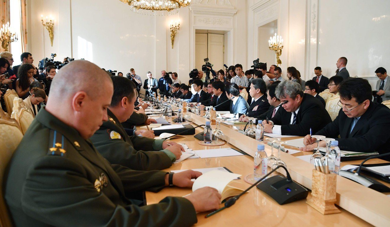 Russian and Japanese officials attend a meeting in Moscow on Tuesday. Photo: AFP