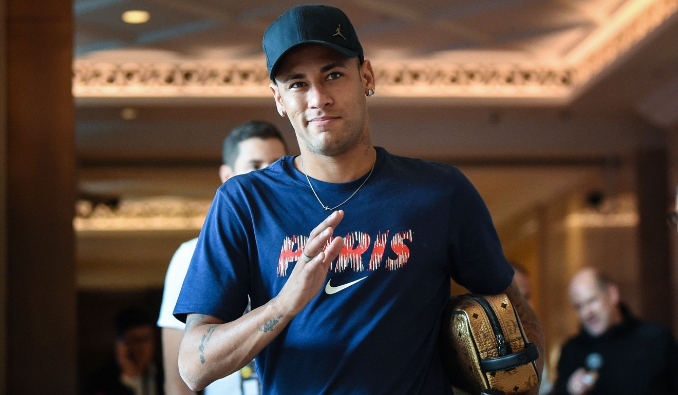 Neymar gestures as he leaves his hotel to attend a training session in Shenzhen. Photo: AFP
