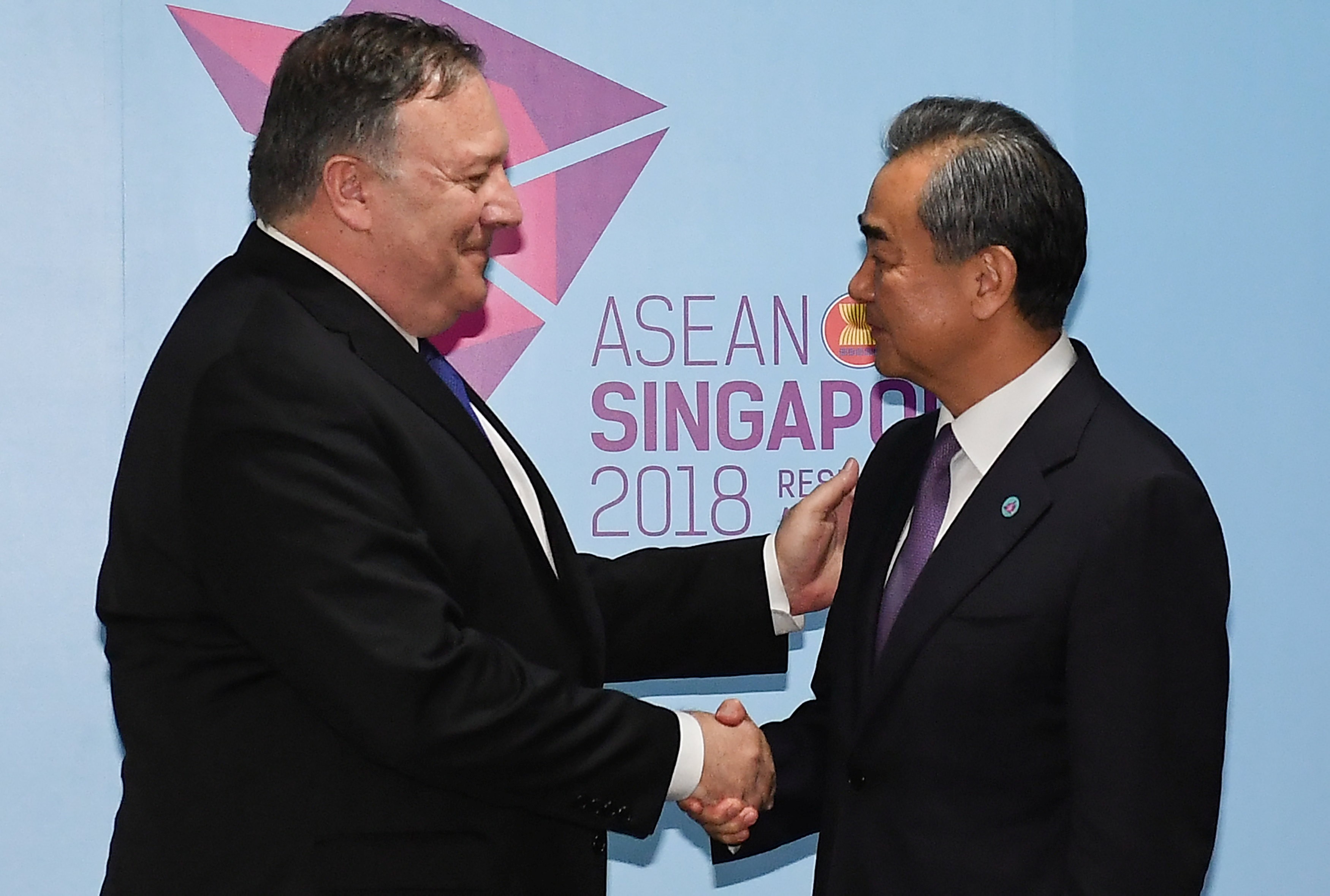 US Secretary of State Mike Pompeo and China's Foreign Minister Wang Yi shake hands before their bilateral meeting at the 51st Association of Southeast Asian Nations in Singapore. Photo: Reuters