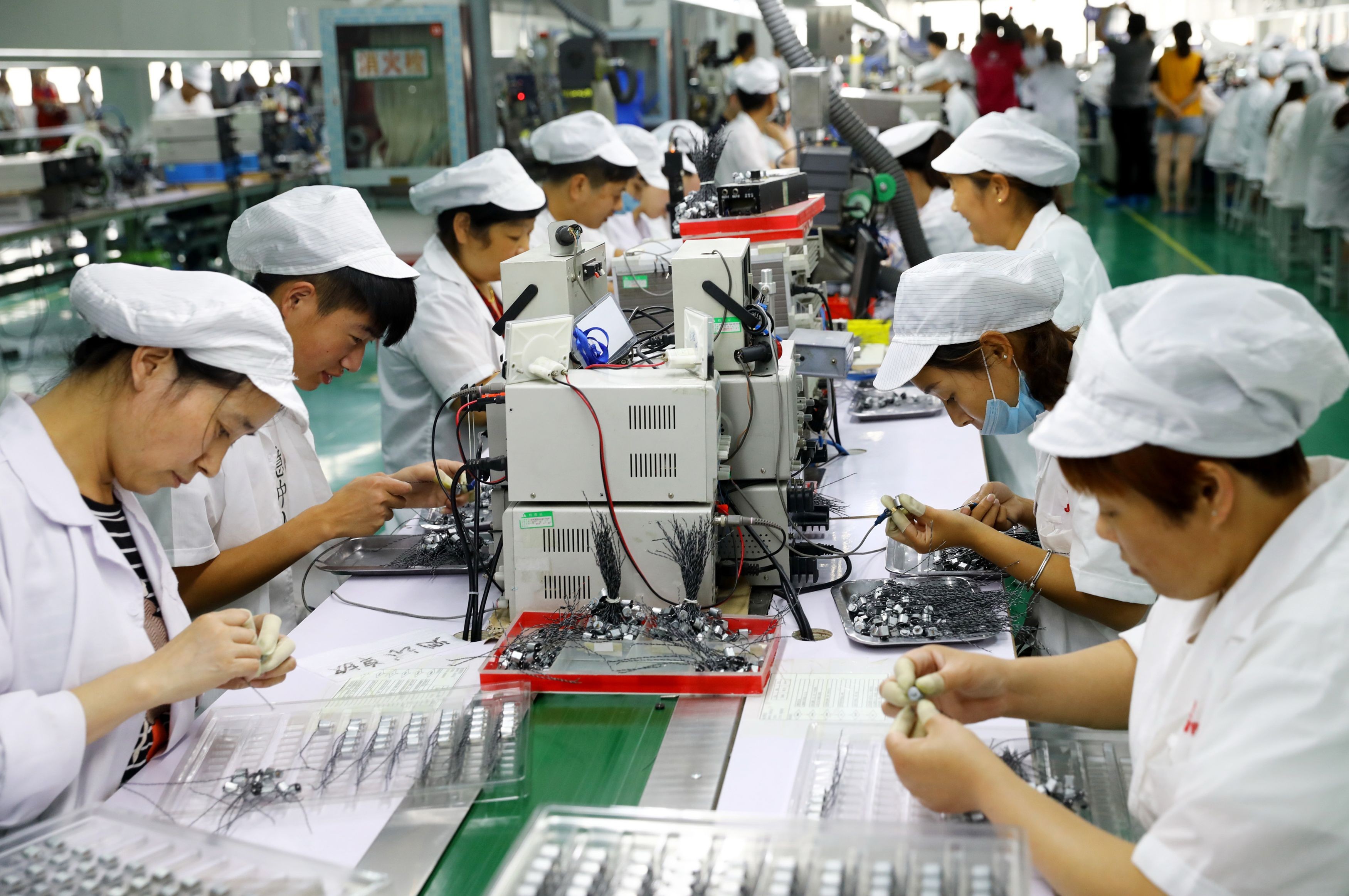 Staff work on a micro motor production line at a factory in Huaibei, Anhui province. Beijing wants banks to improve their internal systems to encourage lending to small business. Photo: AFP