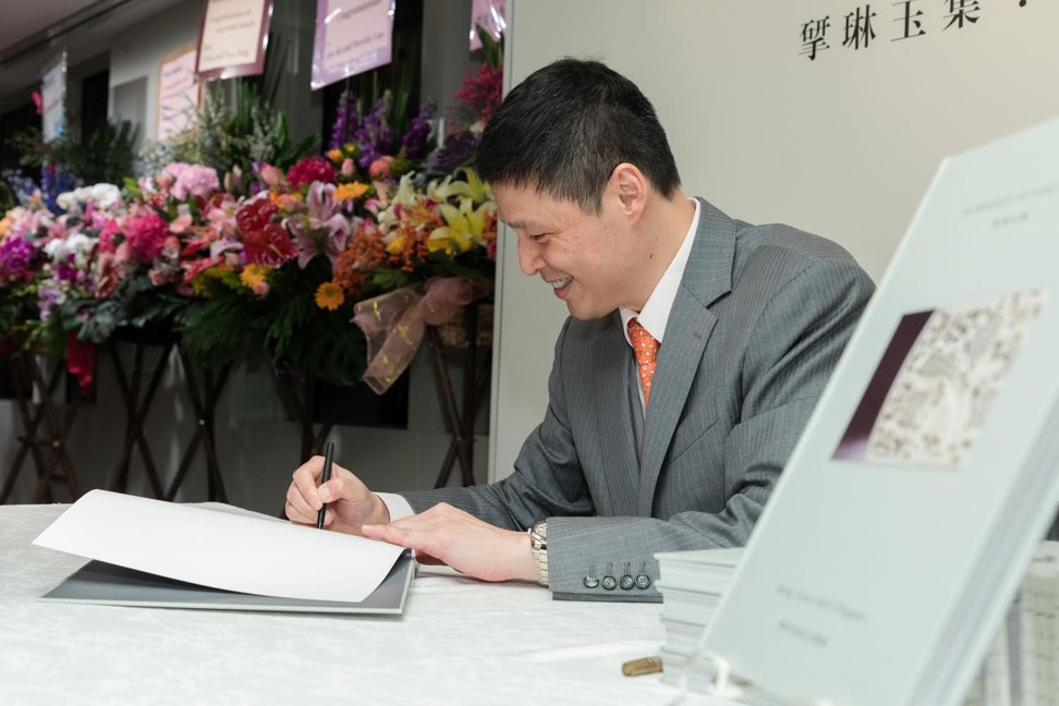 Jade collector and author Michael Liu signs a copy of his book, ‘In Pursuit of Fine Jades: Ming Court Belt Plaques’, during its launch.